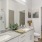 bathroom with large counter with 2 sinks and a large mirror