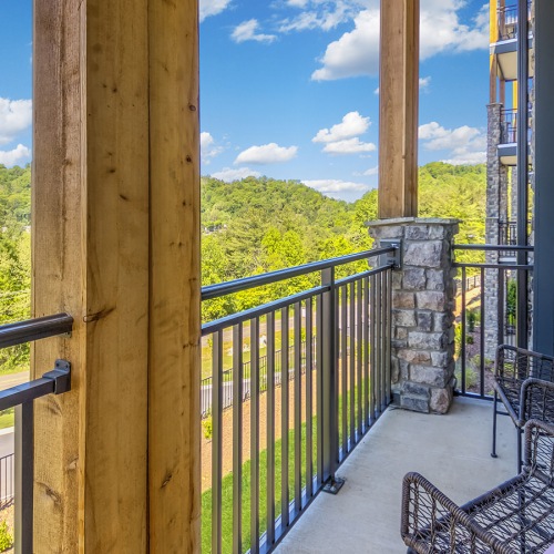 Settle into comfort at Enclave Piney Mountain patio with large wood beams and a view of trees