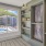 hallway with a bookshelf and large window with view of pool