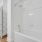 built-in shelving next to shower/tub combo in bathroom