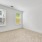 two windows in bright bedroom with carpet