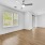 ceiling fan and light fixture in living room with windows